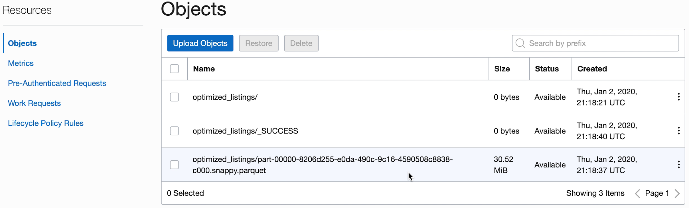 The Objects section is displayed. There are three buttons, Upload Objects, Restore, and Delete. Only the first is active. Below is a table of four columns, Name, Size, Status, and Created. the objects available are listed.